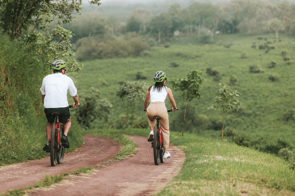 Couple riding bikes on a road